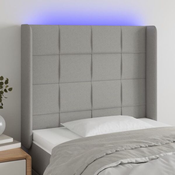 vidaXL Čelo postele s LED světle &scaron;ed&eacute; 83 x 16 x 118/128 cm textil