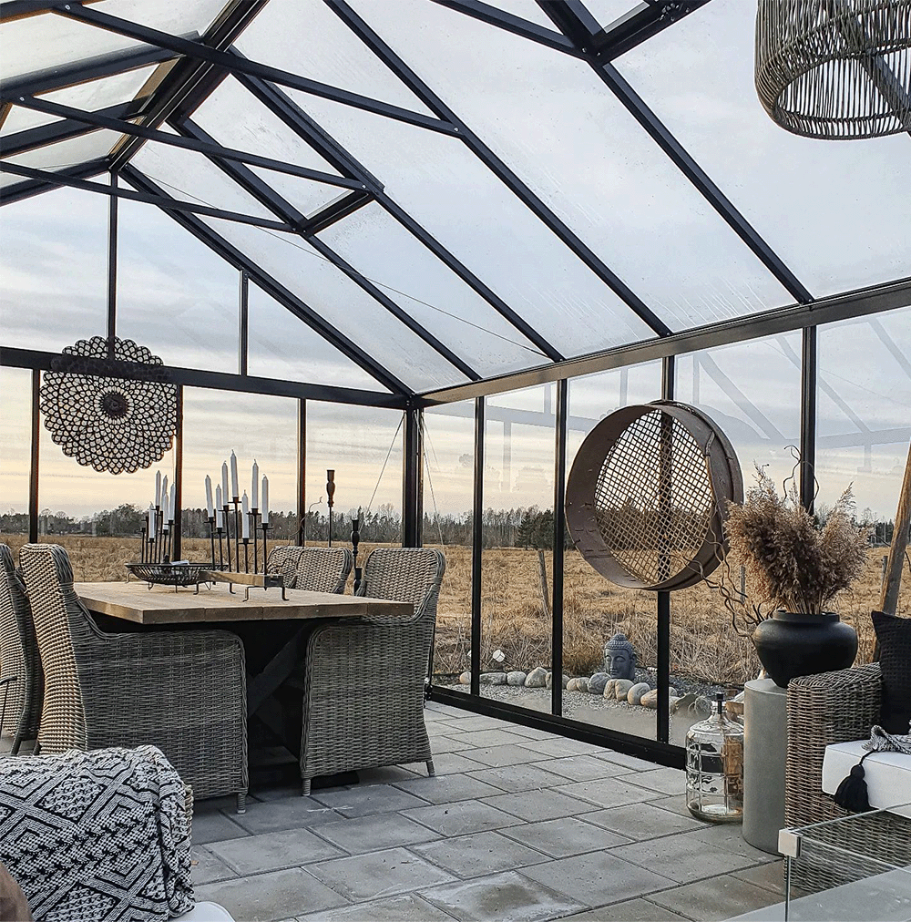 Outdoor seating area with glass roof and walls